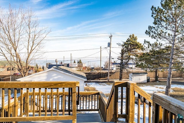 deck with an outdoor structure and fence