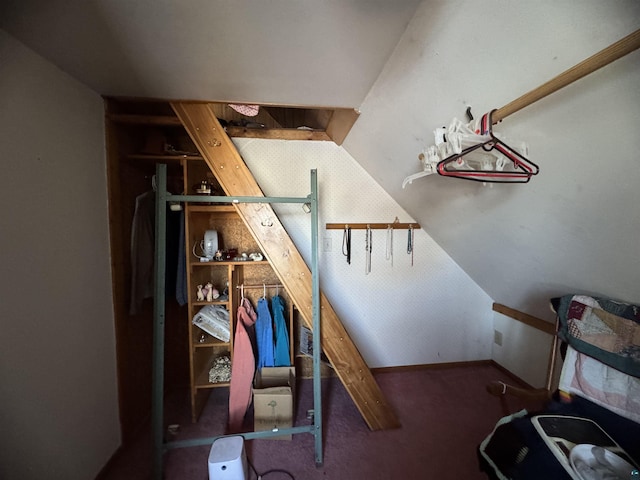 interior space featuring lofted ceiling and carpet flooring