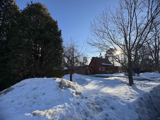 yard covered in snow with a garage