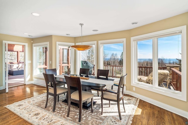 dining space featuring recessed lighting, baseboards, and wood finished floors