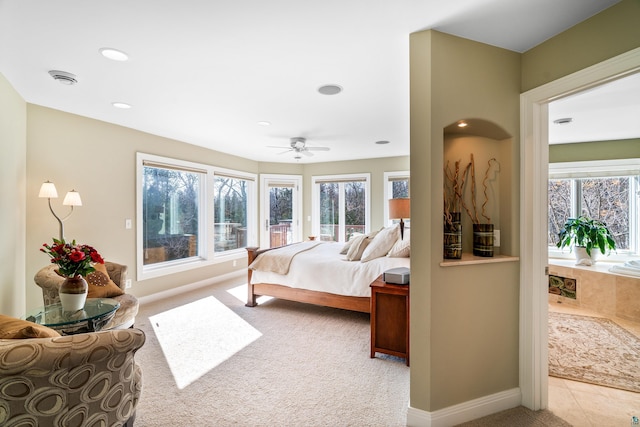 bedroom featuring light tile patterned flooring, recessed lighting, baseboards, and light colored carpet