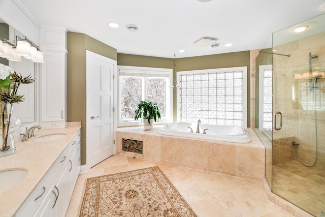 full bathroom with a sink, visible vents, a shower stall, a bath, and double vanity