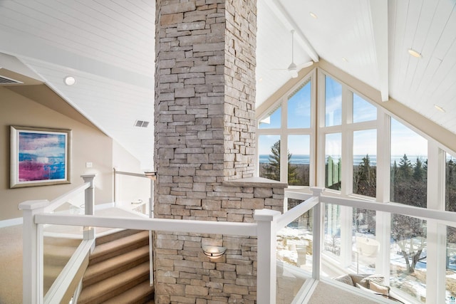 interior space featuring high vaulted ceiling, ceiling fan, visible vents, and beamed ceiling