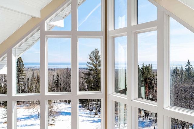 sunroom featuring beamed ceiling and plenty of natural light