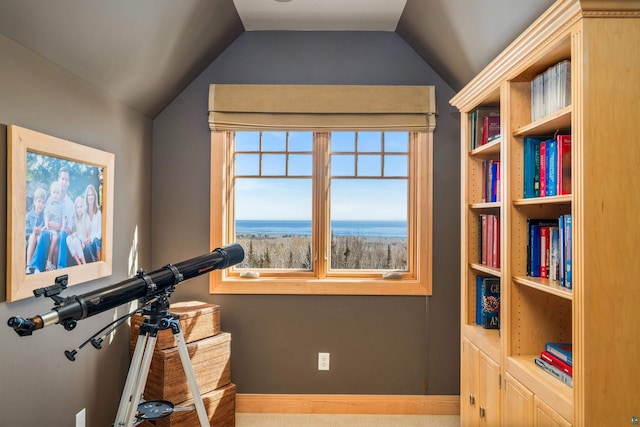 workout room with vaulted ceiling and baseboards