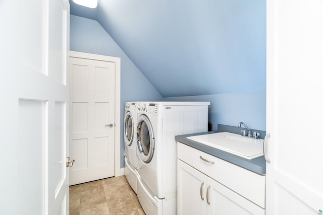 washroom with cabinet space, a sink, and separate washer and dryer