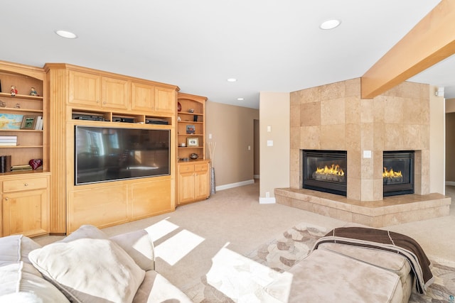 living room featuring beam ceiling, recessed lighting, light carpet, a tile fireplace, and baseboards