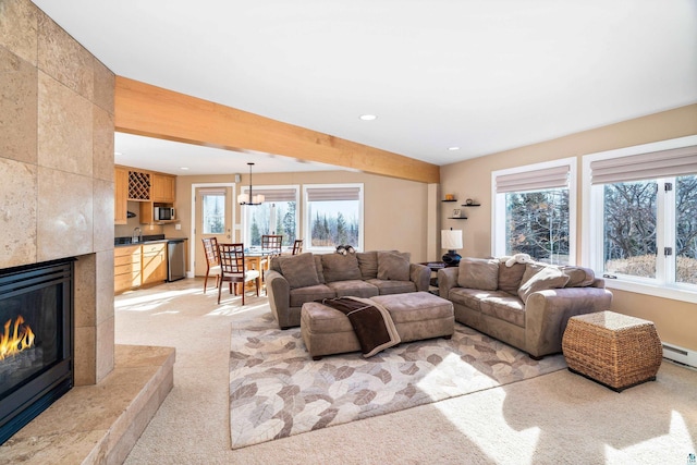 living room featuring light colored carpet, a tile fireplace, a healthy amount of sunlight, and recessed lighting