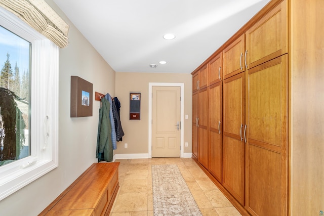 interior space featuring baseboards, a wealth of natural light, and recessed lighting