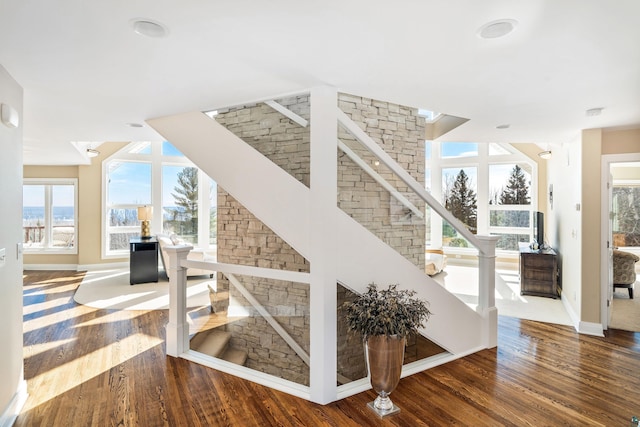 stairway featuring baseboards and wood finished floors