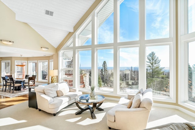 sunroom featuring lofted ceiling and visible vents