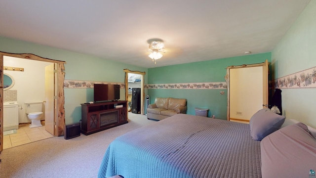 bedroom featuring ensuite bathroom and carpet floors