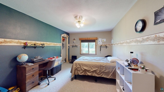 bedroom with carpet floors and a textured ceiling