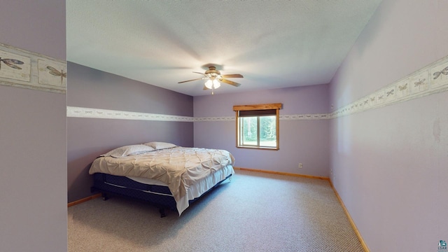 bedroom featuring carpet flooring, a ceiling fan, baseboards, and a textured ceiling