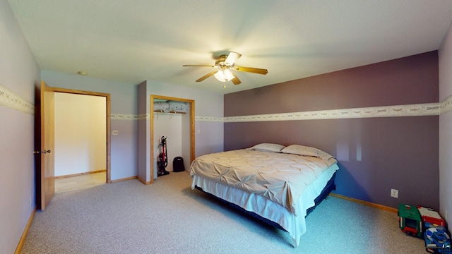 bedroom with a closet, ceiling fan, baseboards, and carpet floors