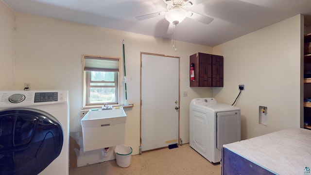 laundry room featuring washer and clothes dryer, cabinet space, a ceiling fan, and a sink