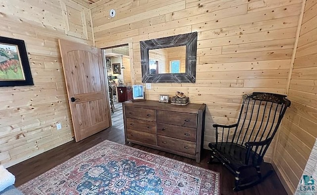 living area featuring wooden walls and wood finished floors