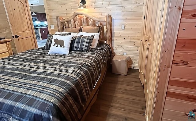 bedroom with wood walls and wood finished floors