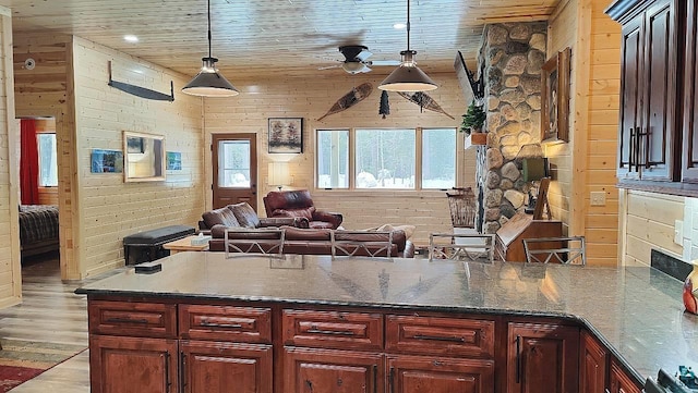 kitchen with wooden ceiling, wood walls, and a peninsula