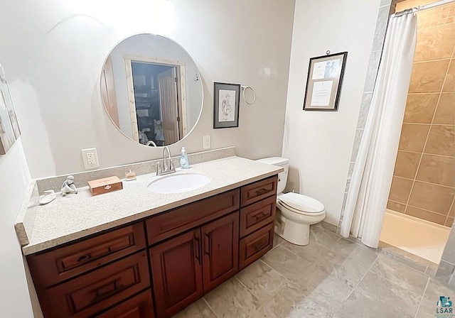 full bath featuring a tile shower, vanity, and toilet