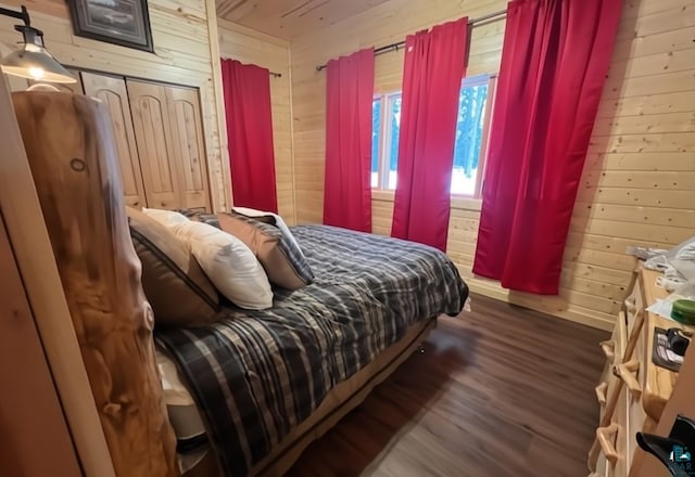 bedroom with wood walls and wood finished floors