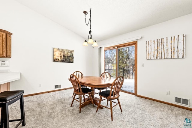 dining space featuring baseboards, visible vents, light colored carpet, lofted ceiling, and a chandelier