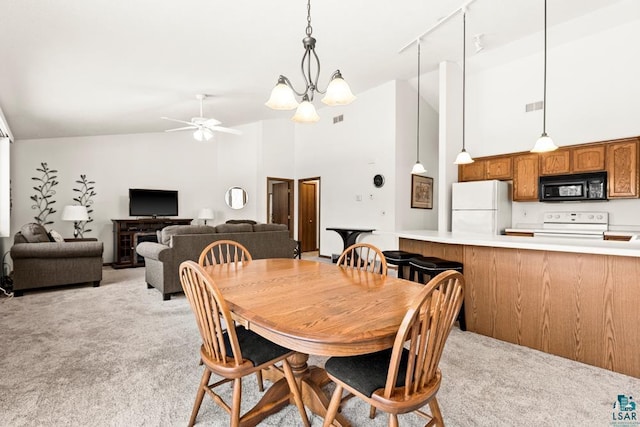 dining space with high vaulted ceiling, light carpet, visible vents, and ceiling fan with notable chandelier