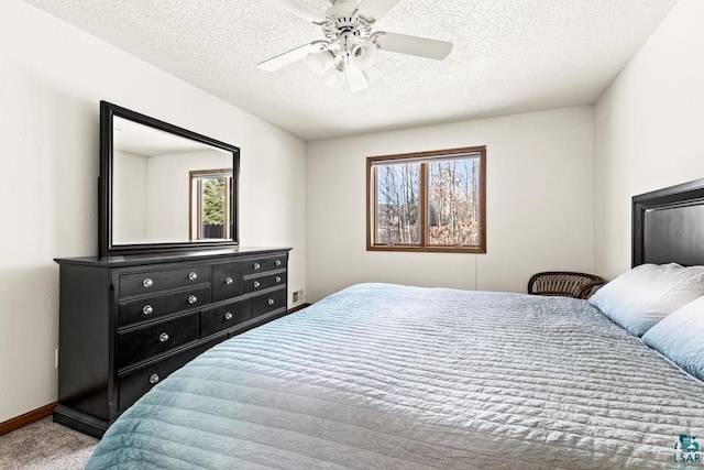 carpeted bedroom with multiple windows, ceiling fan, a textured ceiling, and baseboards