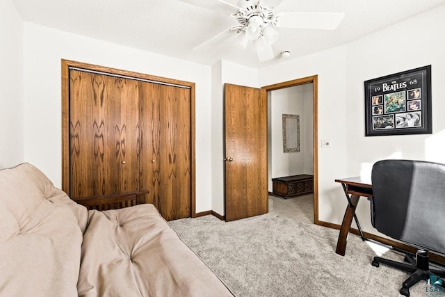 carpeted home office featuring baseboards and a ceiling fan