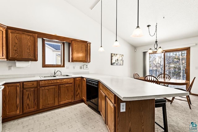 kitchen featuring black dishwasher, lofted ceiling, a breakfast bar, a peninsula, and a sink