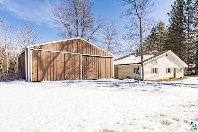 exterior space featuring a garage, a pole building, and an outbuilding