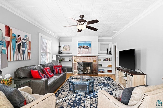 living area featuring ornamental molding, a ceiling fan, a brick fireplace, and wood finished floors