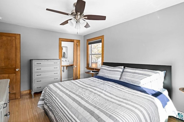 bedroom featuring connected bathroom, a ceiling fan, and hardwood / wood-style floors