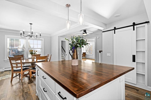 kitchen with dark wood finished floors, white cabinetry, wooden counters, and a barn door