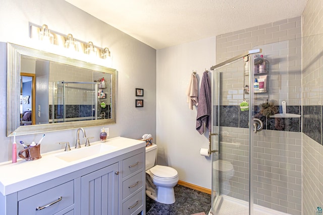 full bath with a textured ceiling, toilet, vanity, baseboards, and a stall shower