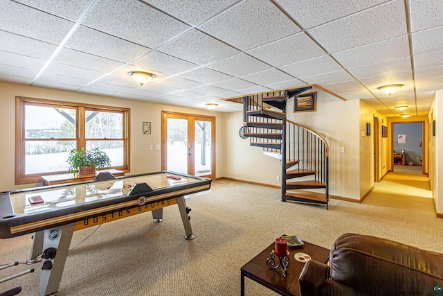 game room with french doors, carpet flooring, a drop ceiling, and baseboards