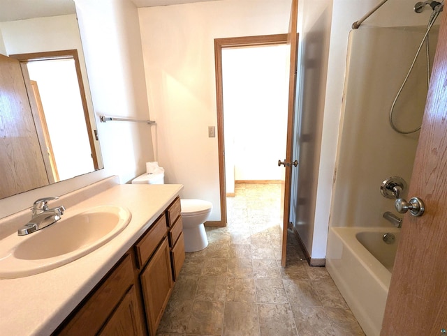 full bathroom featuring shower / bathtub combination, toilet, vanity, baseboards, and stone finish flooring