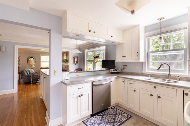 kitchen with a sink, white cabinets, light countertops, dishwasher, and pendant lighting