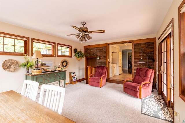 living area with carpet and a ceiling fan