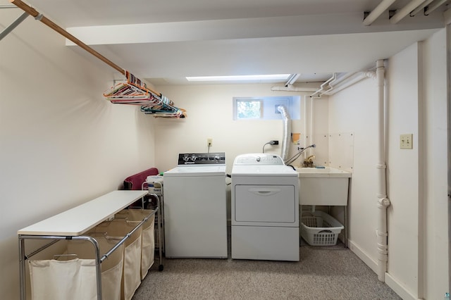 laundry room featuring baseboards, laundry area, a sink, and washer and dryer