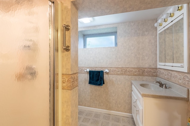 bathroom featuring tile patterned floors, a shower stall, vanity, and wallpapered walls