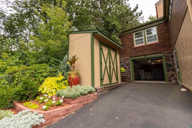 view of shed featuring driveway