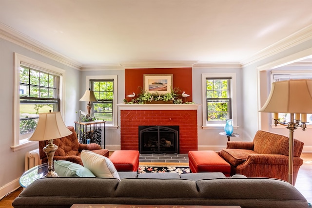 living area with plenty of natural light, a fireplace, and ornamental molding