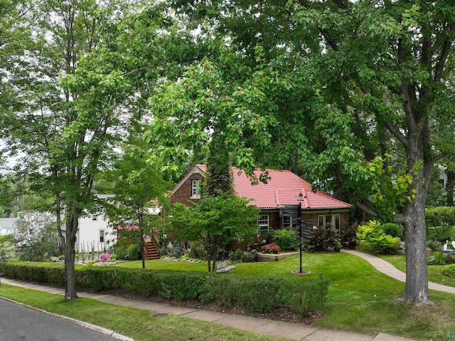 view of front of house with a front yard and a tile roof