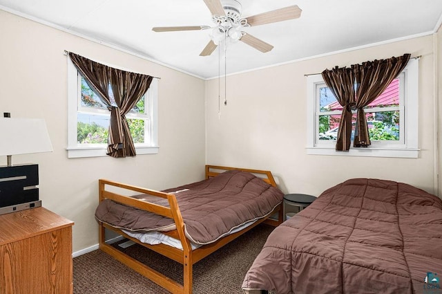 bedroom with baseboards, carpet floors, ceiling fan, and crown molding