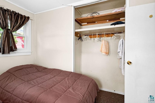 carpeted bedroom with ornamental molding and baseboards