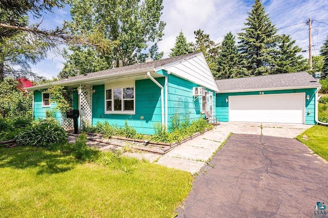 single story home with a garage and a front yard