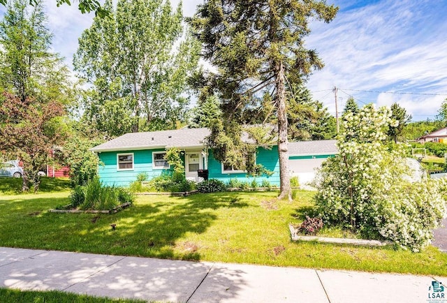 ranch-style home with a front lawn