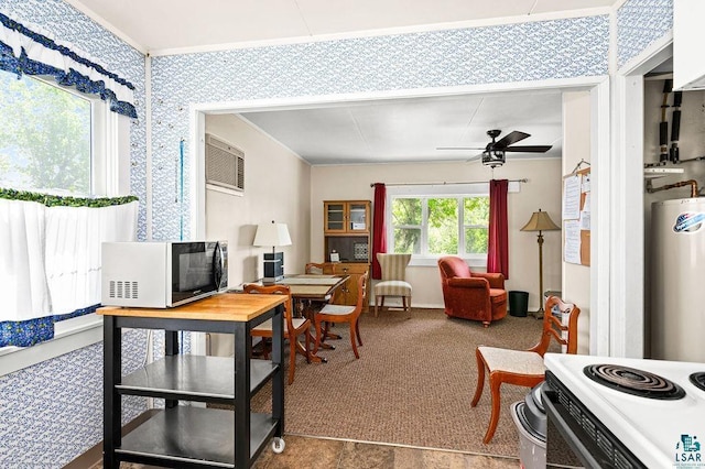 carpeted office space featuring a ceiling fan and water heater