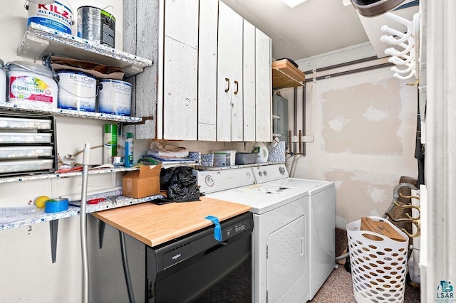 washroom featuring cabinet space and washer and clothes dryer